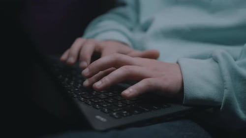 Male IT Worker Typing on a Keyboard
