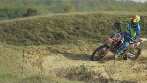 Motocross Rider Drifting on Dirt Track Racing