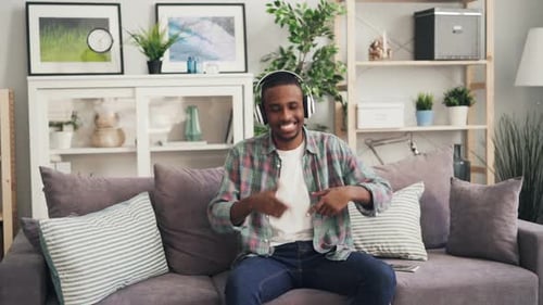 Young Man Listening to Music on Couch