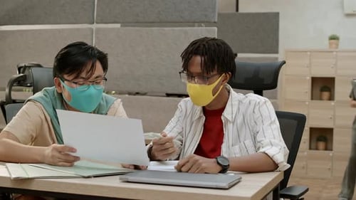 Two Young Adults Working in an Office