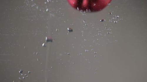 Red Apples Floating in Water with Bubbles