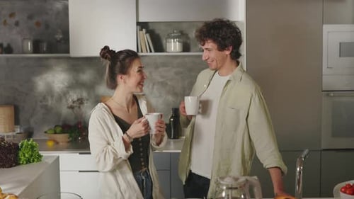 Affectionate Couple Enjoying Coffee Together in Modern Kitchen