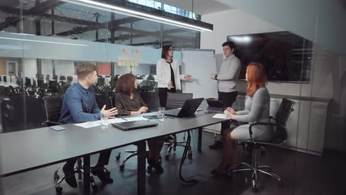 Business Meeting in Modern Office with Whiteboard