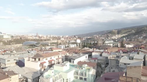 Aerial view of Tbilisi city central park and Bridge of Peace. Beautiful cityscape of old Tbilisi