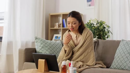 Woman Telemedicine Doctor Visit Home Sick in Blanket