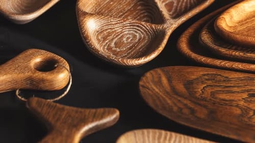Rustic Wooden Plates and Bowls on Dark Surface