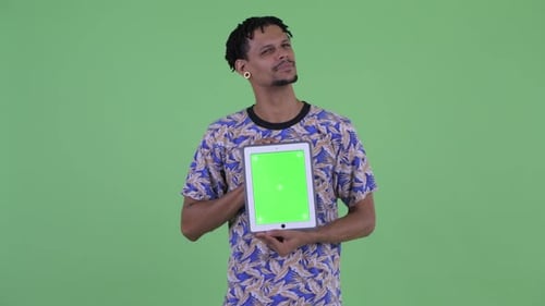Young Man Holding Tablet with Green Screen Display