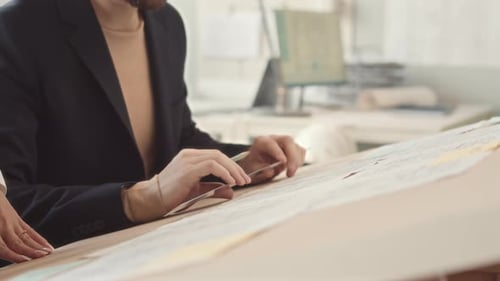 Architect Engineers Drawing Blueprint in Office