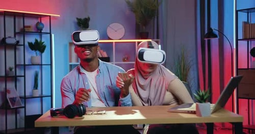 Couple Enjoys Virtual Reality at Home with Headsets