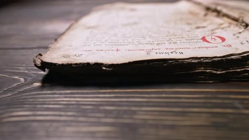 Old Book Lying Open on Wood Table