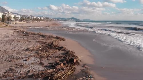 Dirty polluted sea coastline with debris after big torrential rain and floods.
