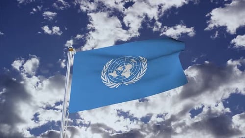 United Nations Flag Waving in Cloudy Blue Sky
