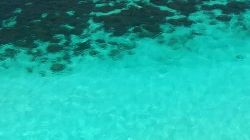 Aerial drone seascape of exotic tourist beach by blue ocean with sand background