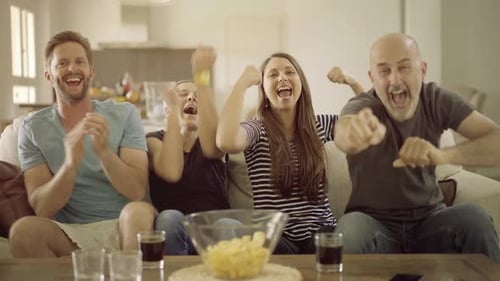 Friends Celebrate Together on Couch in Living Room