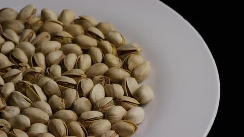 Pistachios on White Plate, Close-up Studio Shot