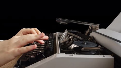 The girl is typing on a retro typewriter. Alpha channel included.