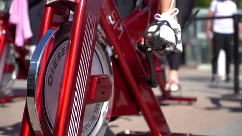 Legs Pedaling on Stationary Bike Outdoors in City