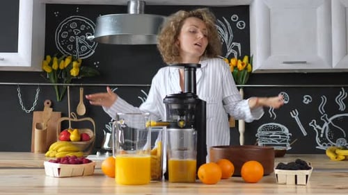 Woman Dances in Kitchen Making Fresh Juice