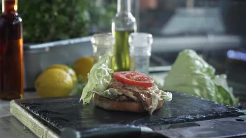 Juicy Meat Burger on Bun with Cheese and Cheese Placed on Grill Board and Prepared for Serving in