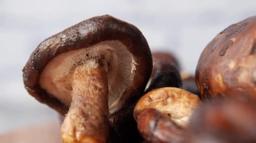 Raw Champignon Mushroom on a Chopping Board on Table