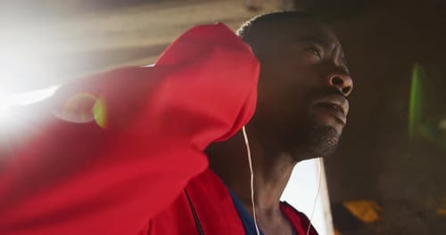 Adult with Earphones Pauses During Workout