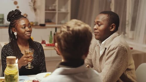 Afro-American Man Giving a Toast and Drinking Wine at Holiday Dinner