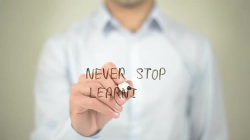 Never Stop Learning, Businessman Writing on Transparent Screen