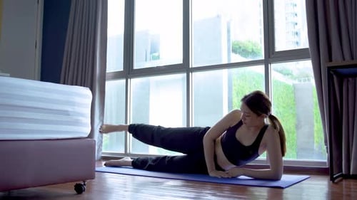 Woman Doing Leg Lifts in Home Studio