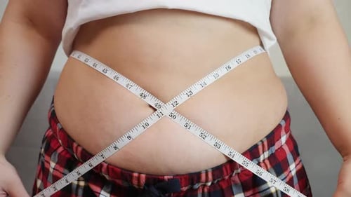 Overweight, Fat Woman Measuring Her Stomach
