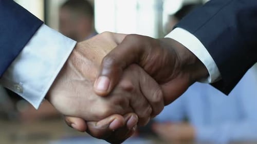 Business Handshake Signifying Successful Deal in Office
