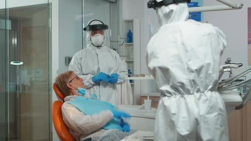 Dentist Examining Patient's Teeth in Hospital Setting