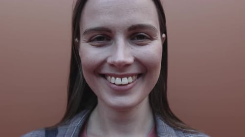 Close Up Young Adult Woman Dressed in Suit Smiling and Looking at Camera