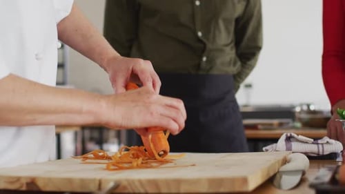 Chef Prepares Carrot with Vegetable Peeler