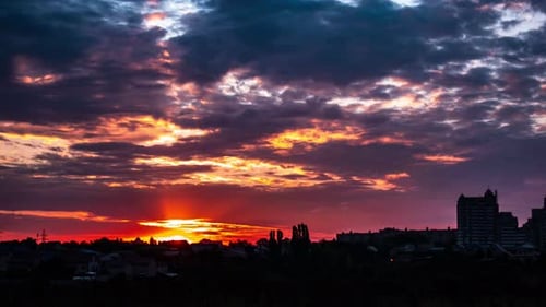 Suburb Silhouettes Against the Backdrop of a Colorful Sunset of Shining Clouds