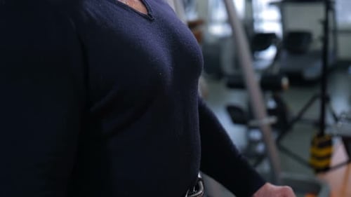 Adult Bodybuilder Straining Chest Muscles and Smiling Slow Mo