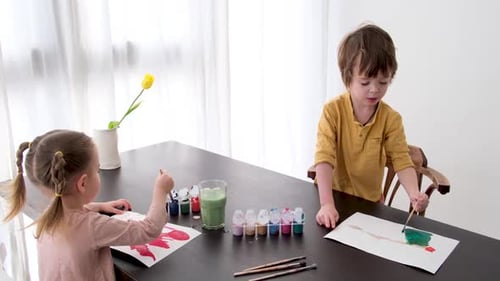 Children Painting Pictures Together at Home
