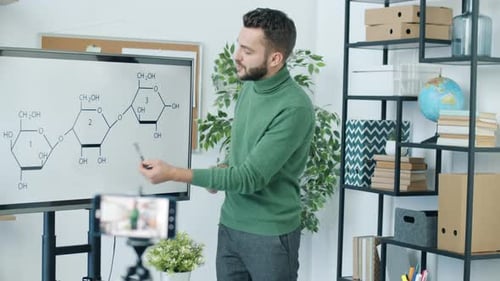 Young Adult Explains Science Diagram to Camera