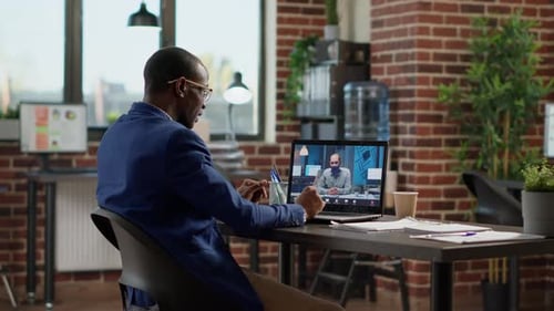 Man Attending Virtual Meeting in Modern Office