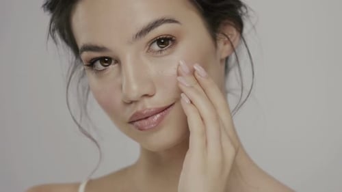Beautiful Woman Touching Her Flawless Face