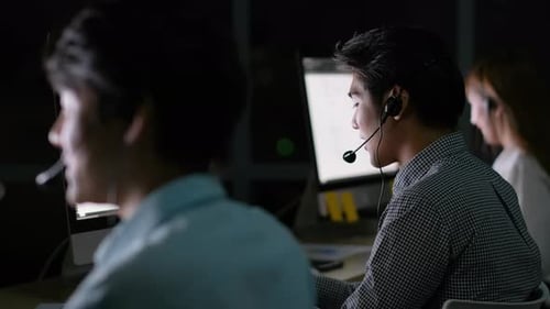 Operator man work together with his team to support the customer at night