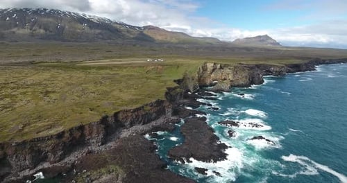 Lava cliffs at Snaefellsnes, Iceland, Snaefellsjokull volcano in the back