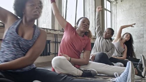 Young Adults Stretching in an Urban Fitness Class