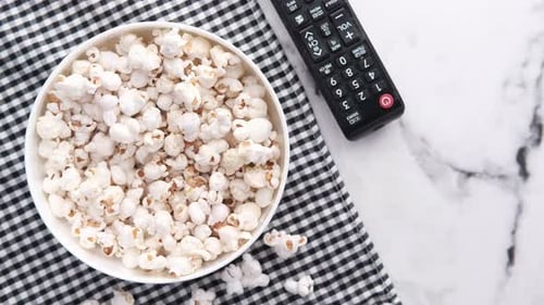 High Angle View of Popcorn and Tv Remote on Table