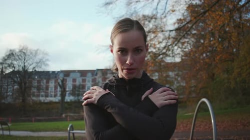 Woman Exercises in Urban Park in Fall