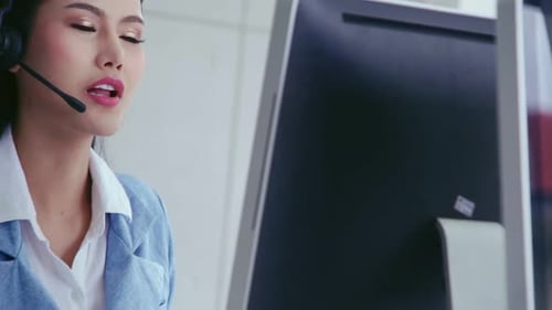 Customer Support Agent or Call Center with Headset Talking to Customer on Phone