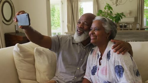 Senior Couple Smiling and Taking a Selfie at Home