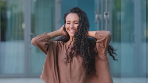 Woman with Curly Hair Shaking Her Head and Smiling