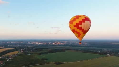 Hot Air Balloon in the Sky Over a Field