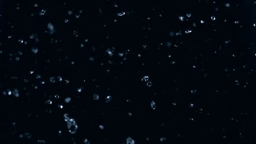 Rain Droplets Falling Up on a Black Backdrop