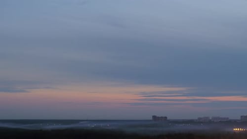 Scene with distant high-rise houses and fog in the dusk